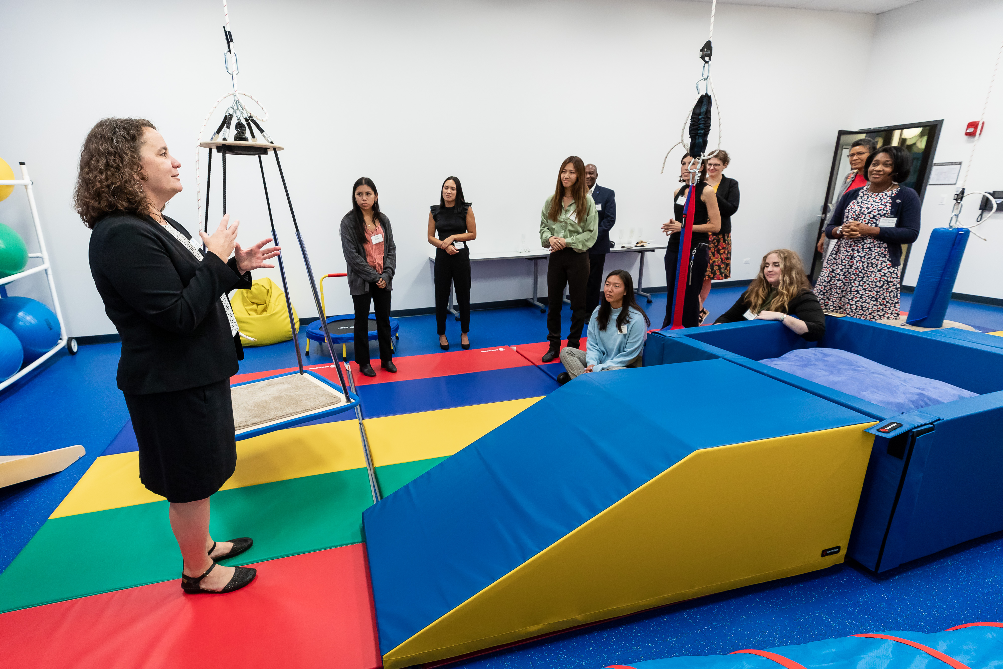 A group of people in a room with colorful mats and blocks