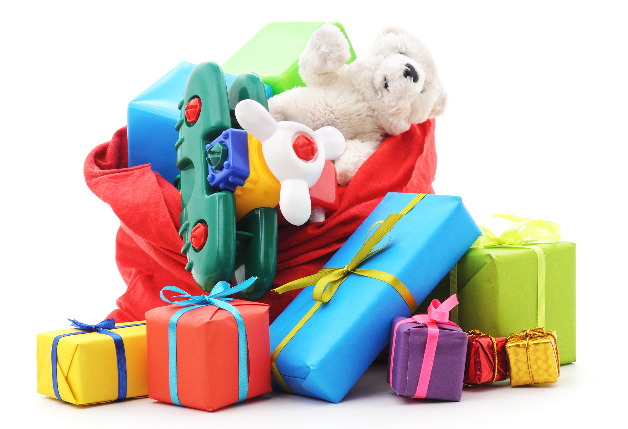 Stack of colorful wrapped presents and a plush teddy bear