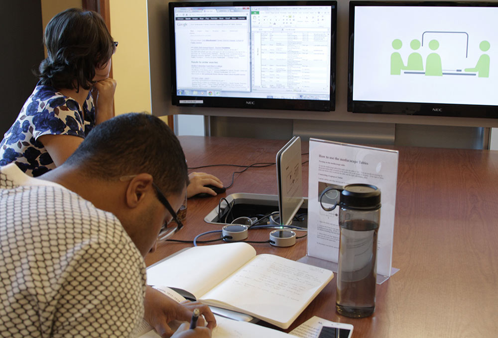 Two students working in the library.