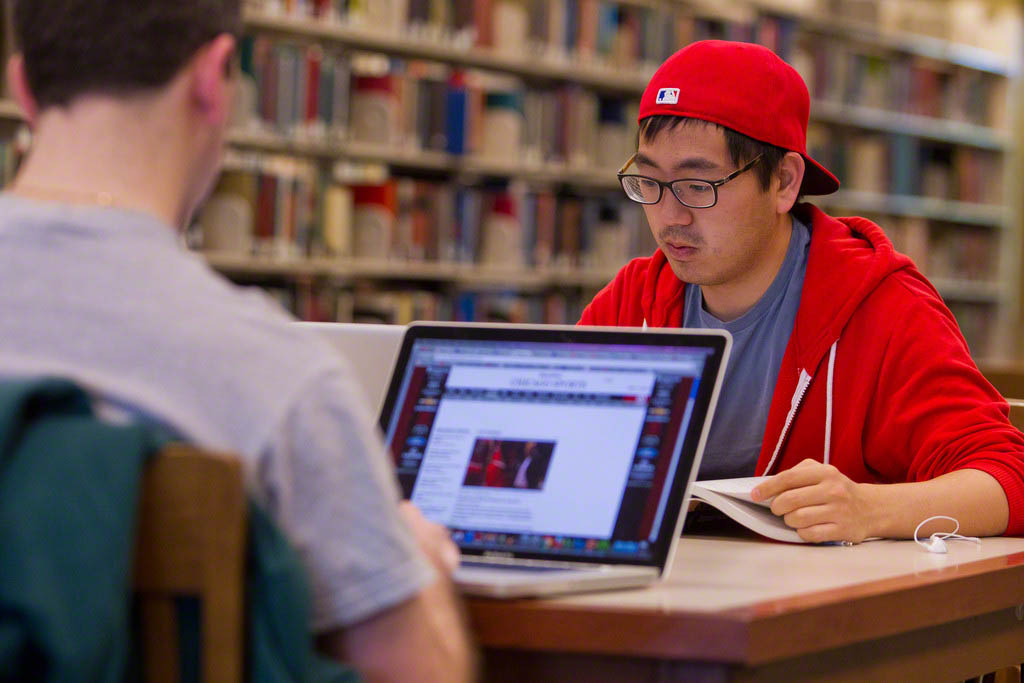 Two students studying in the library.