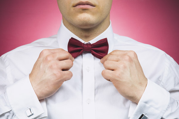 A man wearing a white shirt with a bow tie