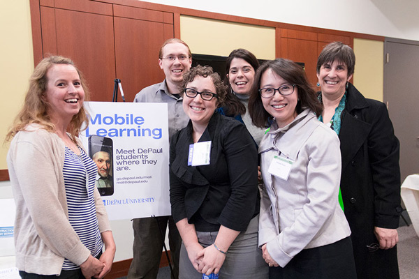Students smiling at the camera during a conference.